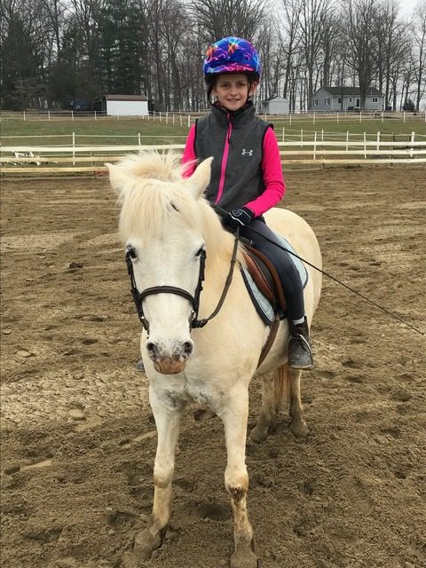 Young Rylen on a pony in the arena